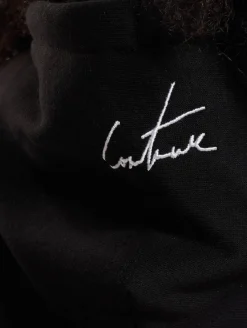 Sweater & Pullover*The Couture Club Oversize-Kapuzenpullover mit mehrfarbiger Grafik in Schwarz