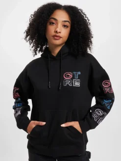 Sweater & Pullover*The Couture Club Oversize-Kapuzenpullover mit mehrfarbiger Grafik in Schwarz